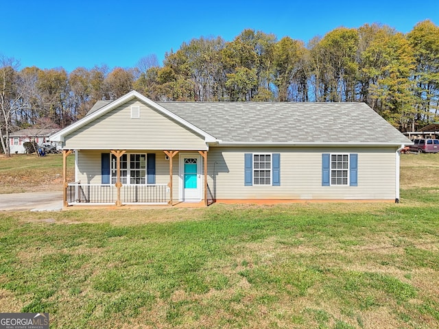 single story home featuring covered porch and a front yard