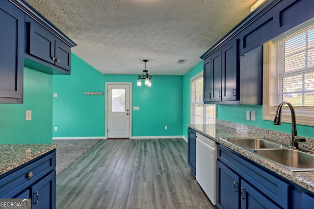 kitchen with stainless steel dishwasher, a textured ceiling, sink, decorative light fixtures, and hardwood / wood-style flooring