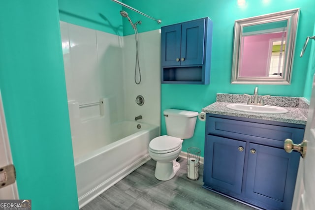 full bathroom featuring vanity, toilet, wood-type flooring, and bathtub / shower combination