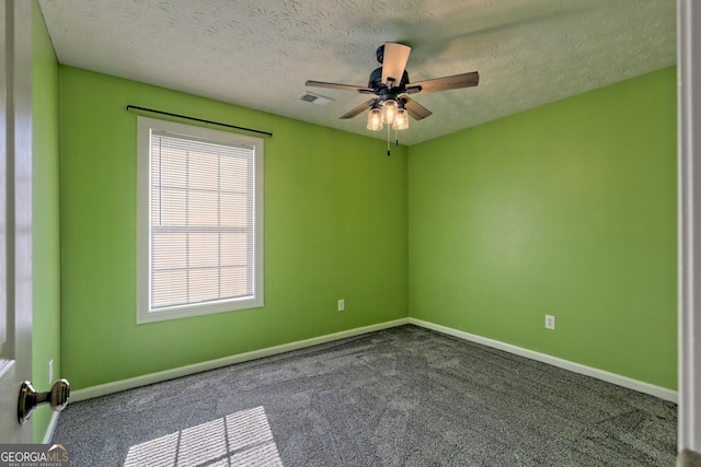 empty room featuring carpet, ceiling fan, and a textured ceiling