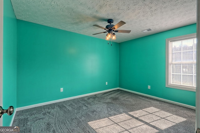 carpeted empty room featuring a textured ceiling and ceiling fan