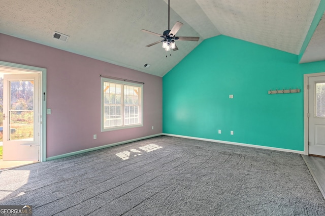 interior space featuring ceiling fan, visible vents, vaulted ceiling, carpet, and baseboards