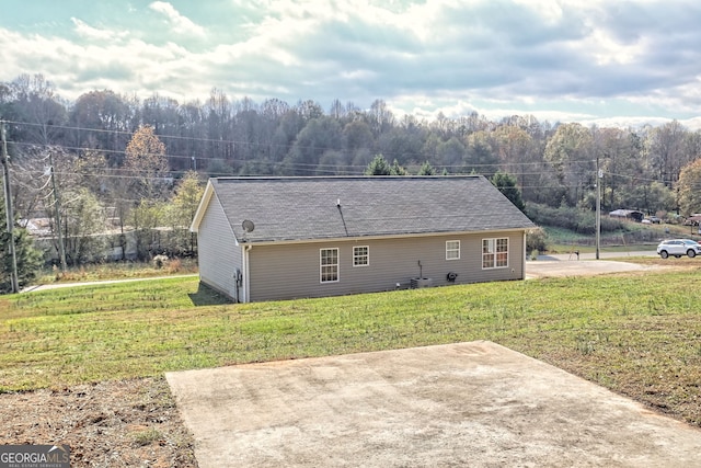 back of property featuring a yard and a patio area