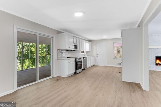 kitchen featuring white cabinets, stainless steel appliances, and light hardwood / wood-style floors