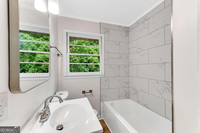 bathroom with vanity, tiled shower / bath combo, and ornamental molding