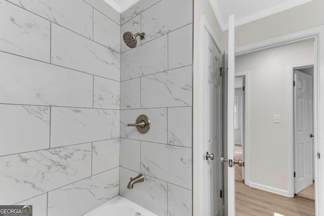 bathroom featuring hardwood / wood-style floors and tiled shower / bath