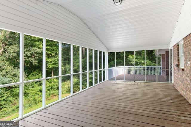 unfurnished sunroom featuring lofted ceiling