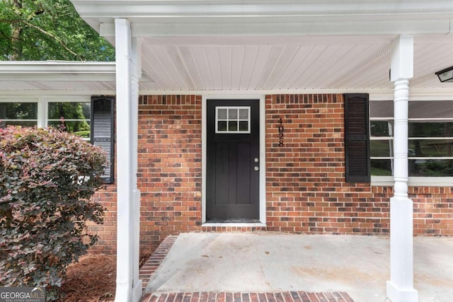 view of exterior entry with covered porch