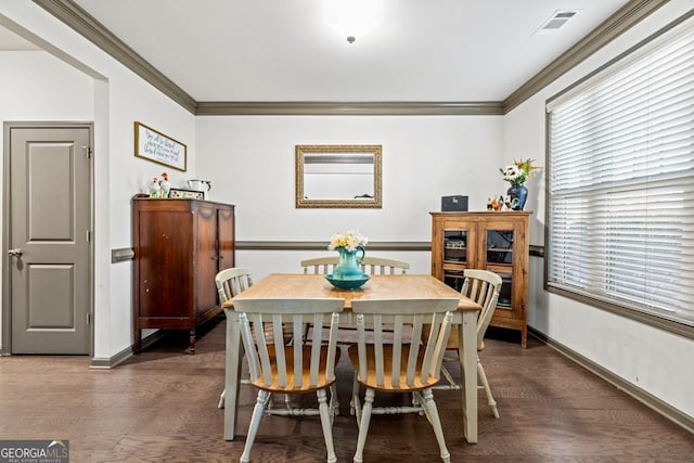 dining area featuring crown molding and dark hardwood / wood-style floors