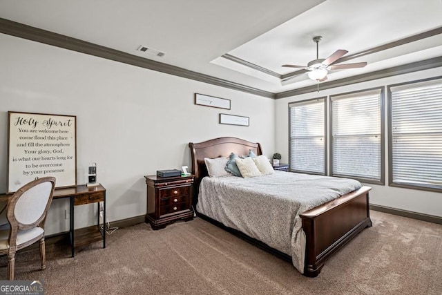 bedroom with carpet flooring, ceiling fan, ornamental molding, and a tray ceiling