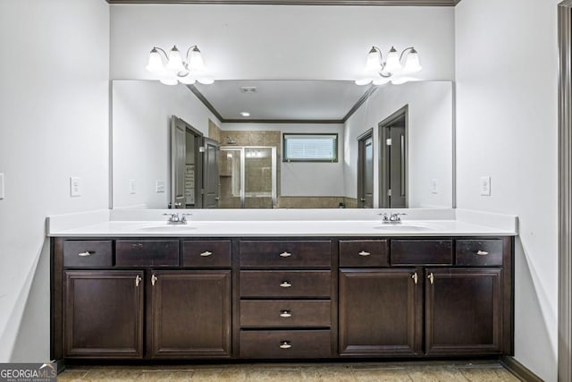 bathroom featuring vanity, crown molding, and a shower with shower door