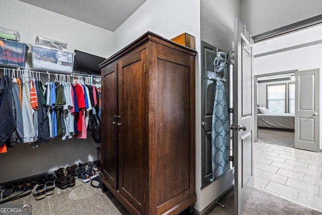 spacious closet with light tile patterned floors