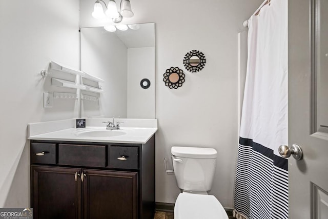 bathroom featuring vanity and toilet