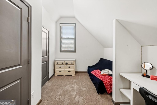 bedroom featuring lofted ceiling and light carpet