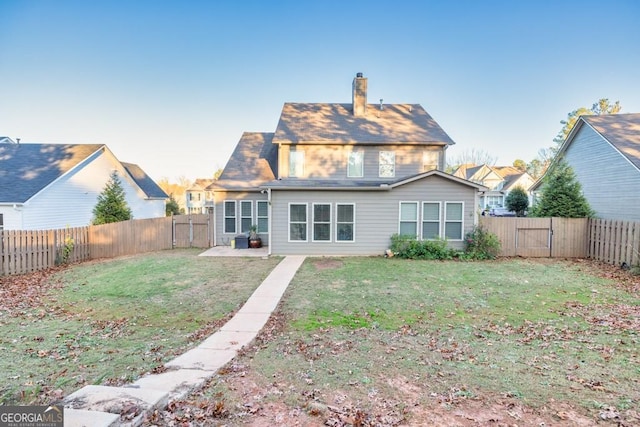 back of property featuring a lawn and a patio