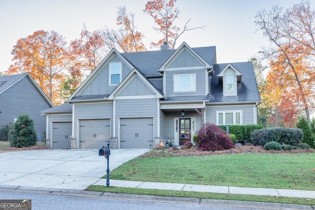 craftsman inspired home featuring a front yard and a garage