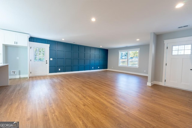 unfurnished living room with recessed lighting, visible vents, and light wood-style floors