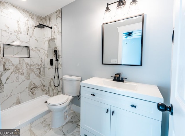 full bath featuring ceiling fan, toilet, vanity, marble finish floor, and a shower stall