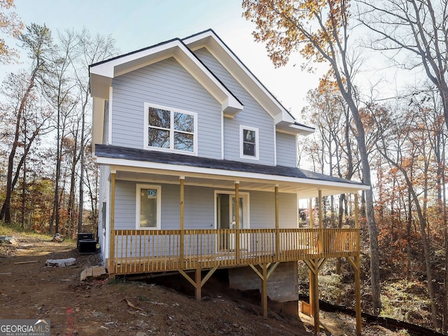 view of front facade with covered porch and central AC