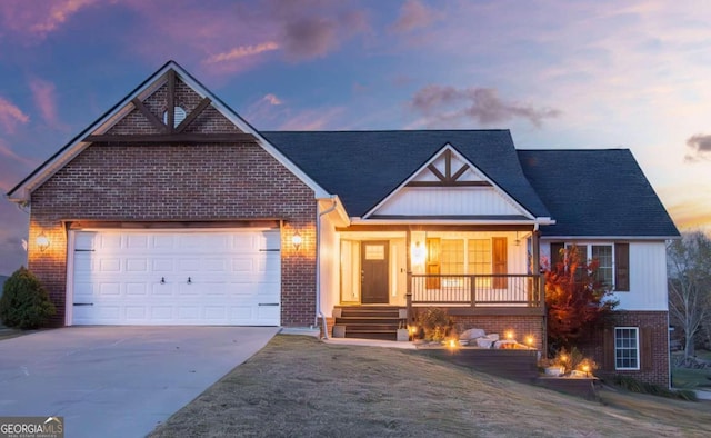 view of front of home featuring a lawn, a porch, and a garage