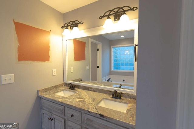 bathroom featuring vanity and a washtub