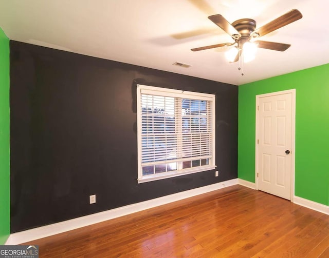 empty room featuring hardwood / wood-style floors and ceiling fan