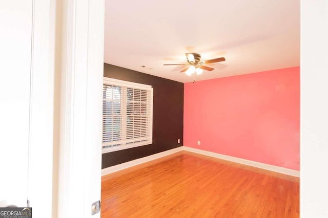 empty room with wood-type flooring and ceiling fan