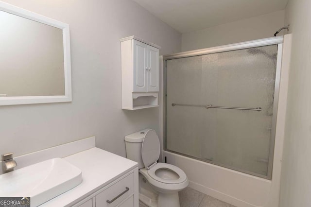 full bathroom with tile patterned flooring, vanity, toilet, and enclosed tub / shower combo