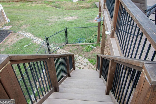 wooden terrace featuring a yard