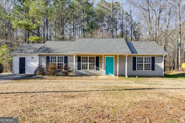 ranch-style house with a front yard and roof with shingles