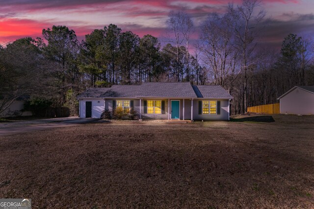 ranch-style home with a front lawn