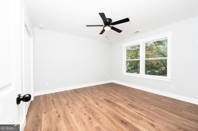 empty room with ceiling fan and light hardwood / wood-style floors