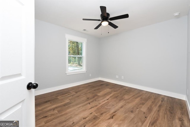 empty room with hardwood / wood-style flooring and ceiling fan