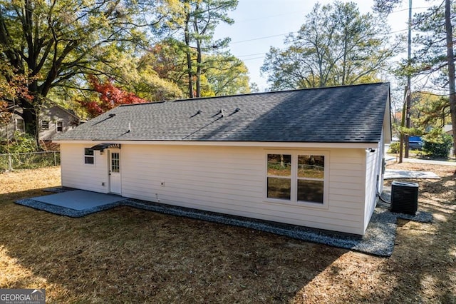 rear view of property with a patio area and central AC