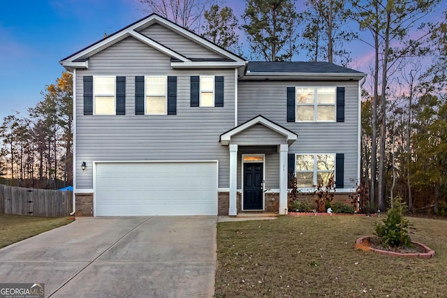 view of front facade with a garage and a yard