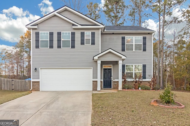 view of front of property featuring a front yard and a garage