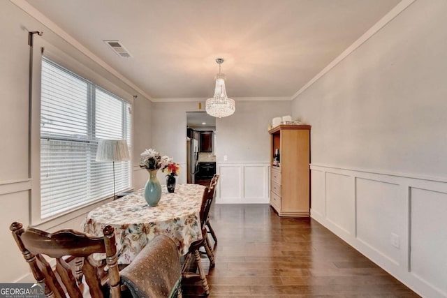 dining space featuring a notable chandelier, dark hardwood / wood-style floors, and ornamental molding