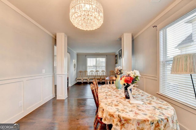 dining room with crown molding, dark wood-type flooring, and a chandelier