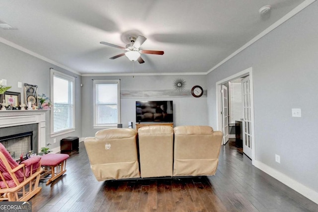 living room featuring dark hardwood / wood-style floors, ceiling fan, and ornamental molding