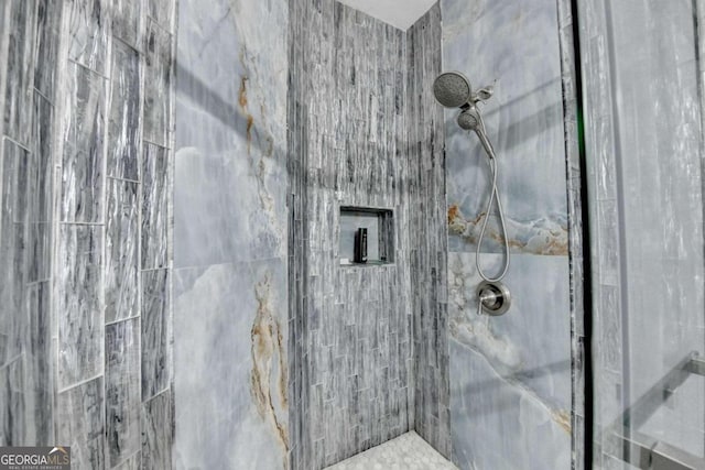 bathroom with tiled shower