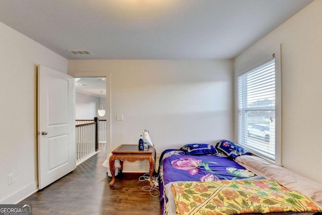 bedroom with dark wood-type flooring