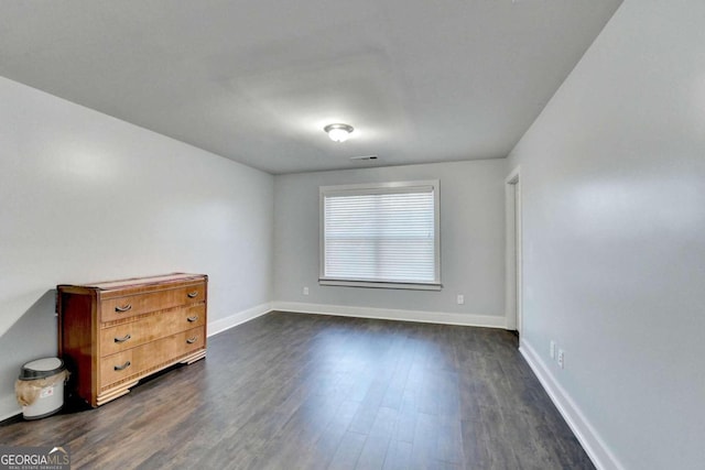 spare room with dark hardwood / wood-style floors