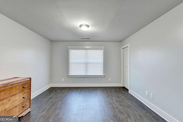 empty room featuring dark wood-type flooring