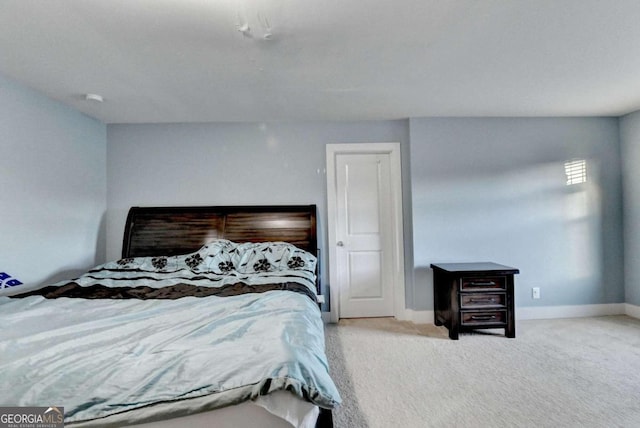 bedroom featuring light colored carpet