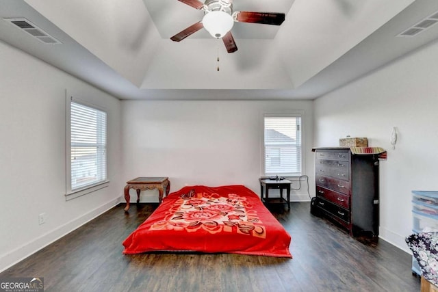 bedroom with dark hardwood / wood-style floors, multiple windows, lofted ceiling, and ceiling fan