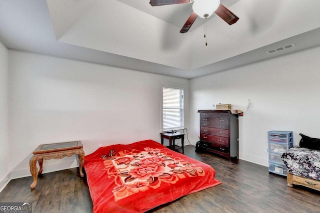 bedroom with dark hardwood / wood-style flooring and ceiling fan