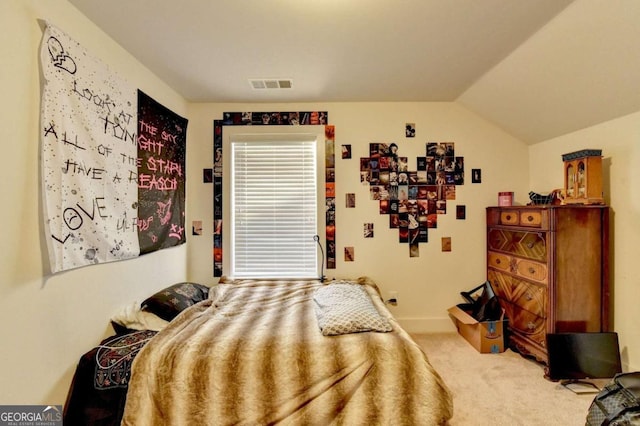 bedroom with carpet floors and vaulted ceiling