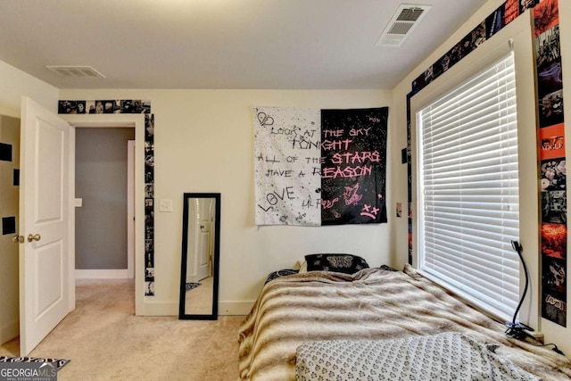 bedroom featuring light carpet