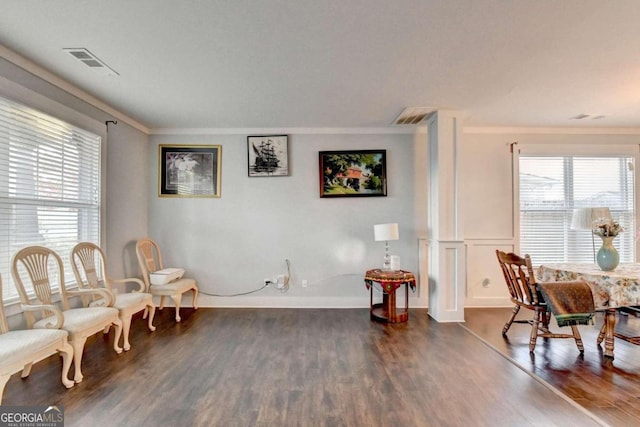 sitting room featuring dark hardwood / wood-style floors and crown molding