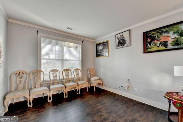 living area featuring dark hardwood / wood-style floors and ornamental molding